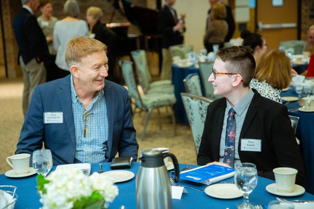 Two guests sitting and chatting at Scholarship Dinner 2019
